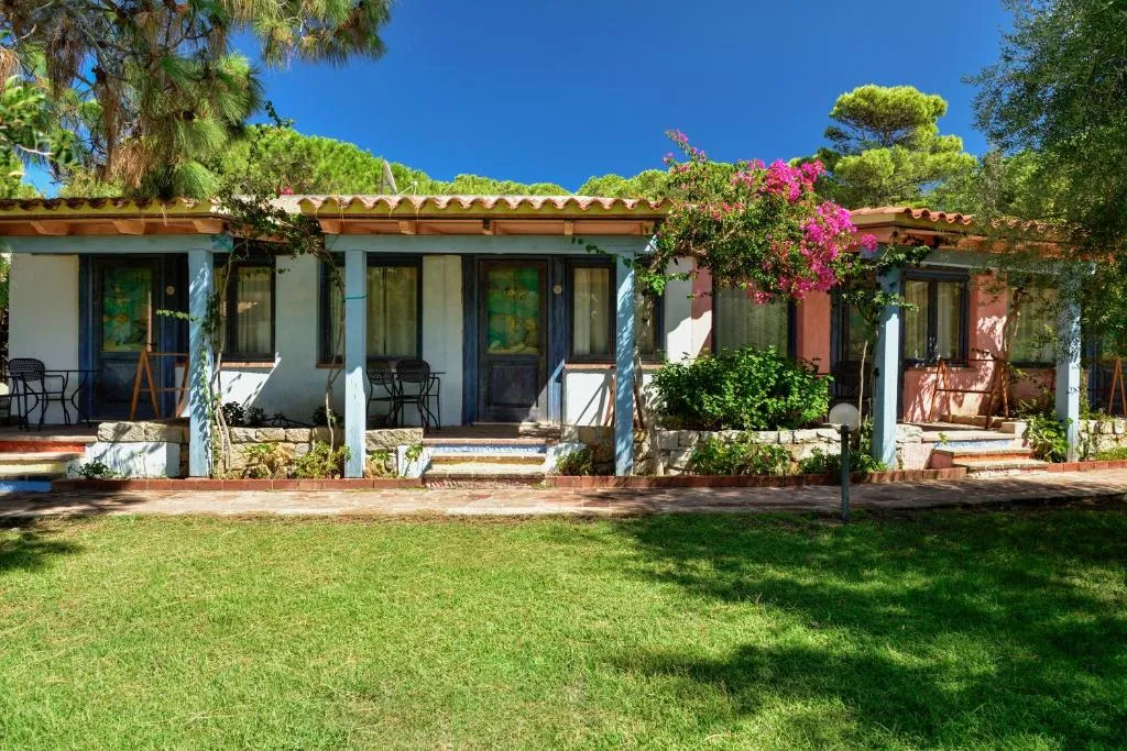 Bungalow del resort con porticato, bouganville e prato verde