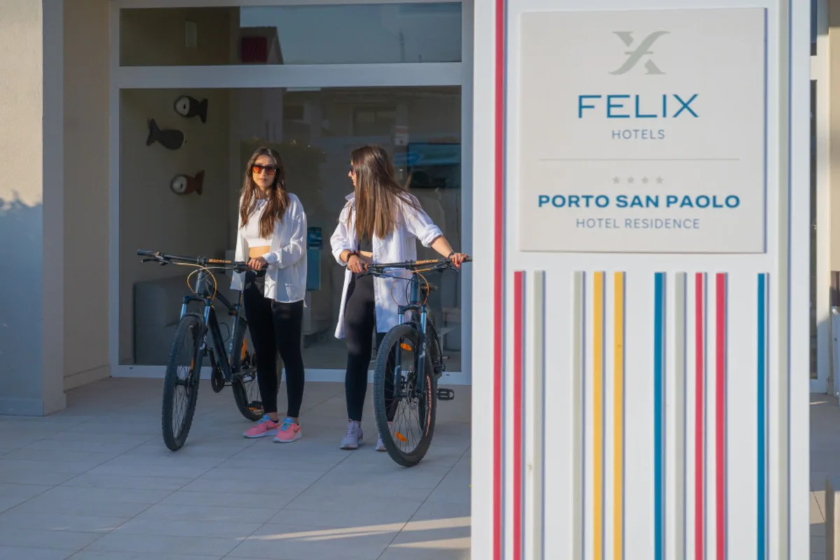 Due donne con biciclette all'ingresso del Felix Hotels Porto San Paolo