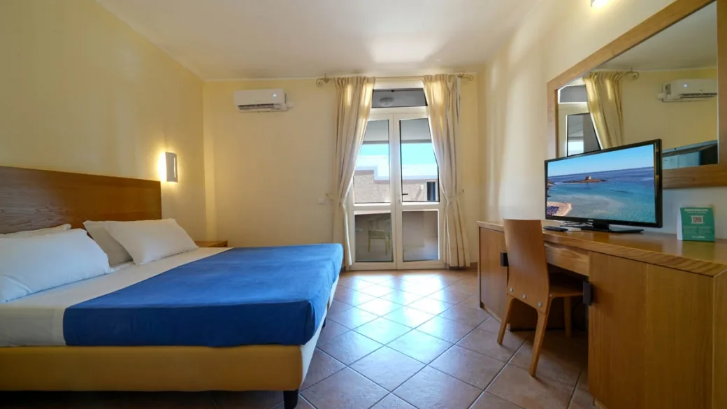 Camera matrimoniale con balcone, scrivania e TV con vista mare