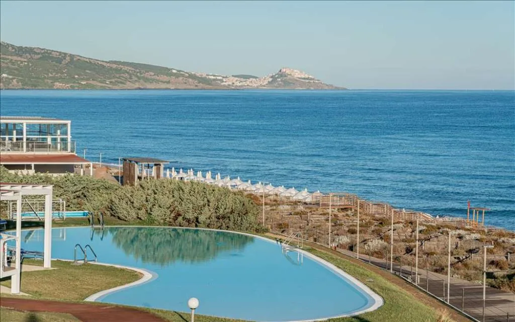 Veduta della piscina e del mare con costa sullo sfondo