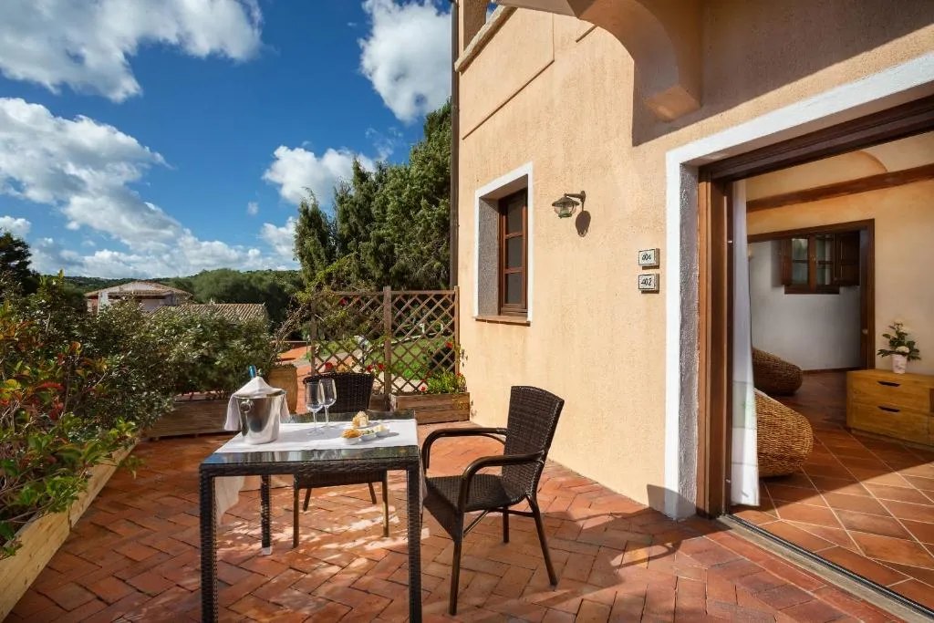 Terrazza privata in cotto con tavolo, sedie e vista sul giardino